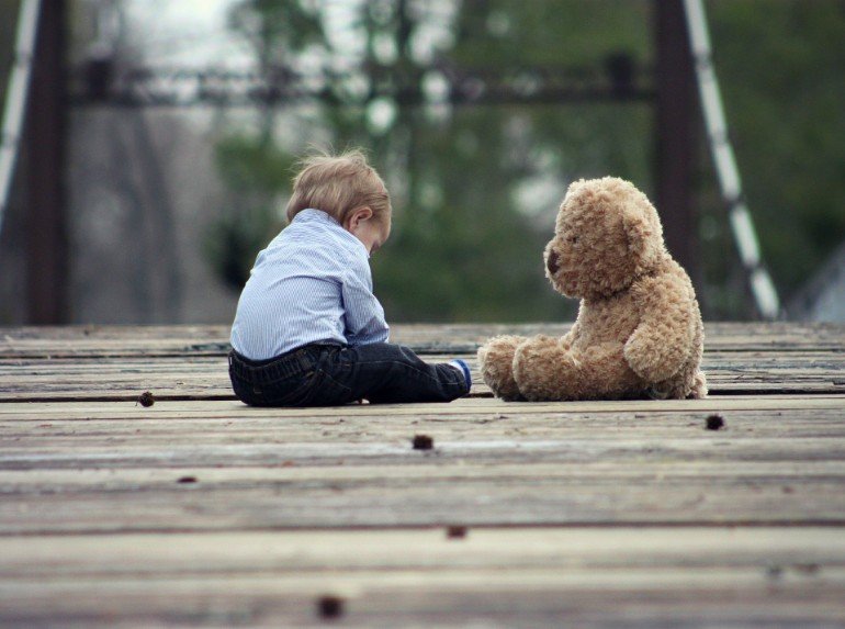 This shows a child and teddy bear