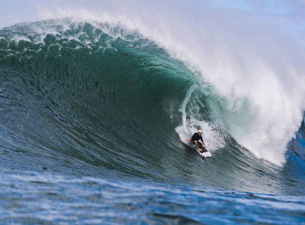<p>Koa Smith surfs Waimea Bay in the Hawaiian island of Oahu.</p>