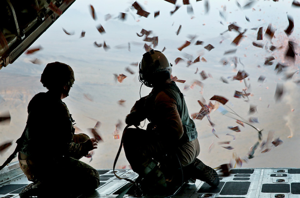 Soldier with 303rd Psychological Operations Company and Marine with Marine Aerial Refueler Transport Squadron 252 watch leaflets fall over southern Afghanistan, August 28, 2013, in support of operations to defeat insurgency influence in area (U.S. Marine Corps/Demetrius Munnerlyn)