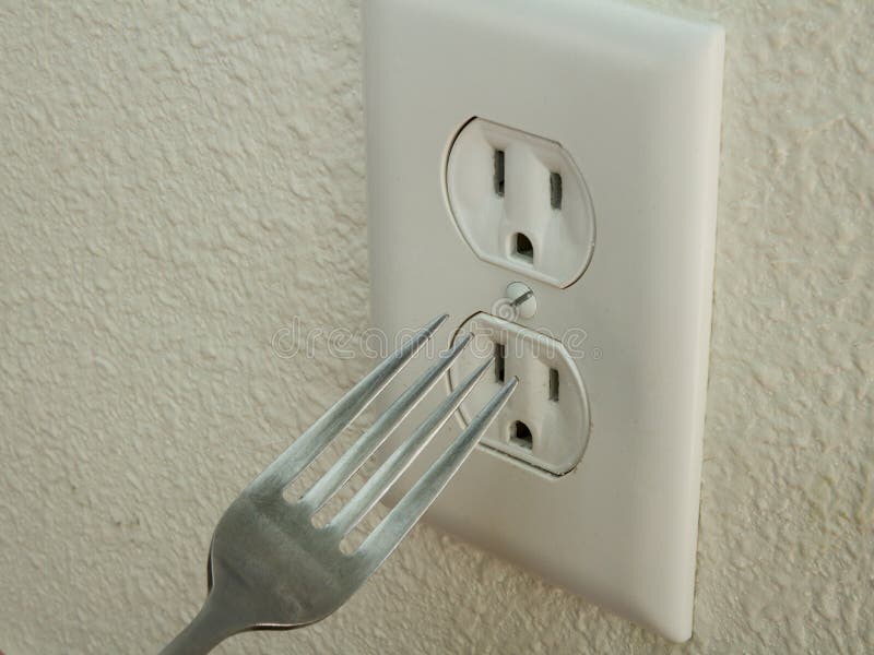 fork-doesn-t-go-outlet-kid-trying-to-put-metal-electrical-63560906.jpg