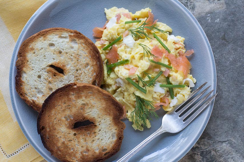 scrambled-eggs-with-smoked-salmon-cream-cheese-chives-nad-dill-on-a-crackled-plate-with-toasted-bagels-2.jpg